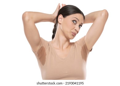 Portrait Of A Beautiful Funny Woman With Sweaty Armpits On A White Studio Background.