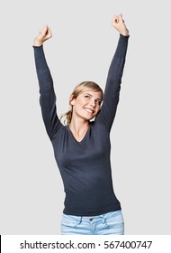 Portrait Of The Beautiful Girl With Arms Up. Young Woman Celebrating And Having Fun