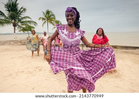 Portrait of a beautiful girl dancing on the beach, wearing a lilac dress.