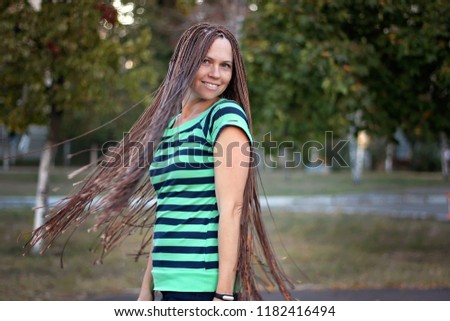 Portrait of a beautiful girl with dreadlocks, autumn outdoor, beauty and fashion 