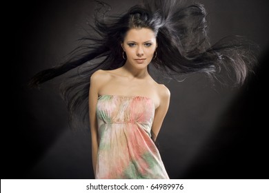 Portrait Of A Beautiful Girl With Flying Black Hair