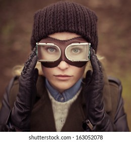 Portrait of a beautiful girl with the ideal face in the form of a vintage aviator