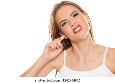 Portrait Of Beautiful Girl With Itch In Her Ear On White Background