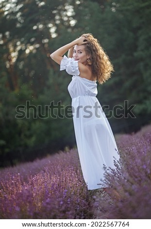 Similar – Woman posing in field of white flowers