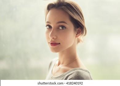 portrait of a beautiful girl on a background of a window - Powered by Shutterstock