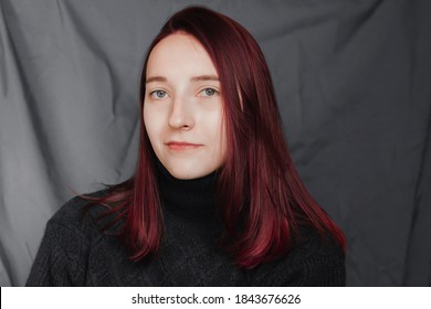 Portrait Of A Beautiful Girl On A Green Background. The Girl With Purple Hair Is Not Looking At The Camera.