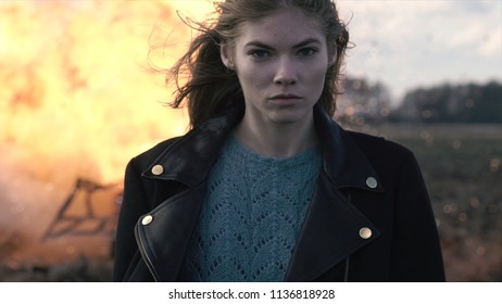 Portrait Of A Beautiful Girl With A Piercing Look And A Car Explosion