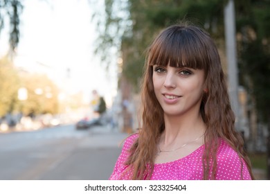 Portrait of beautiful girl in a pink blouse