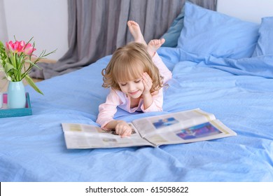 Portrait Of Beautiful Girl Reading A Newspaper At Homein The Newsmodern Children. Concept Of The Happy Babies. Information Protection Of Children