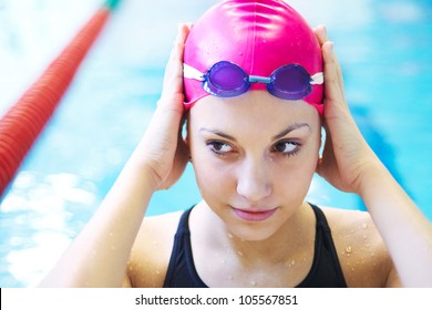 Portrait of a beautiful girl in a red cap at the pool