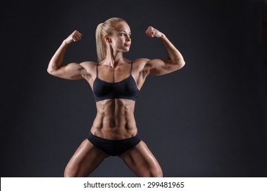 Cute female bodybuilder with muscular body and toned