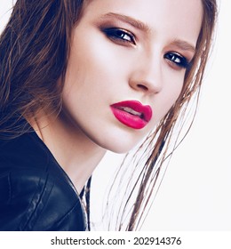 Portrait of beautiful girl in the studio with bright makeup and red lipstick, close up