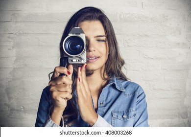 Portrait of a beautiful girl using a video camera