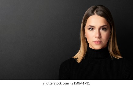 portrait of a beautiful girl's face looking at the camera with black background - Shutterstock ID 2150641731