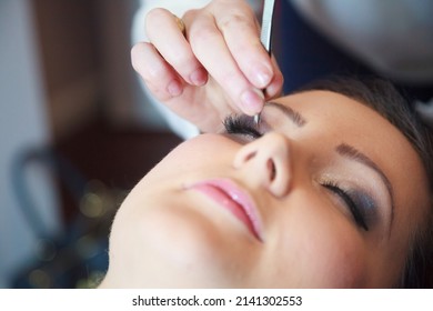 Portrait Of Beautiful Glamour Woman With Dark Curly Hair,make Up Artist Finishing Make Up To Bride At Wedding Morning