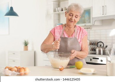 Portrait of beautiful grandmother cooking in kitchen - Powered by Shutterstock