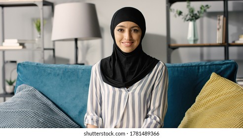 Portrait Of Beautiful Happy Arabic Emirati Lady In Hijab At Home. 