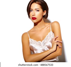 portrait of beautiful happy cute sexy brunette woman with red lips  in pajamas lingerie on white background