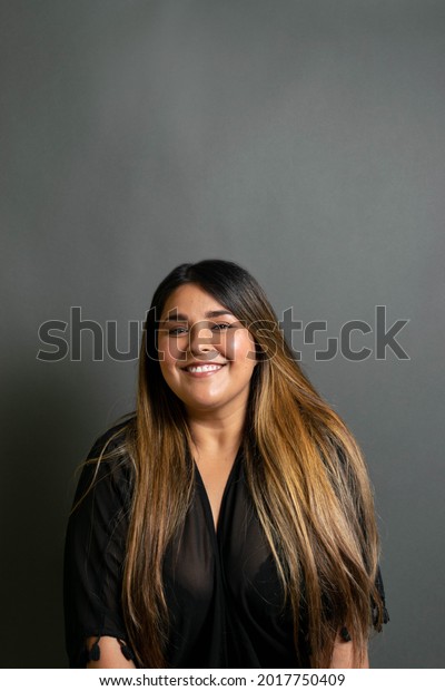 portrait of beautiful and happy latin woman\
smiling. mexican\
chubby