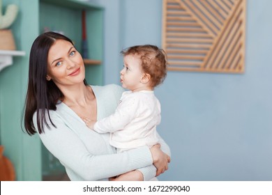 Portrait Of A Beautiful Happy Mom And Little Baby Looking At Camera.