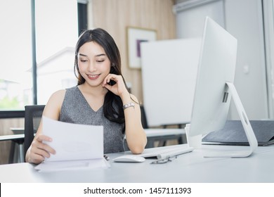 Portrait of beautiful happy smiling young businesswoman working on her computer in the office.,sitting on workplace.,Happy working.