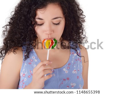 Portrait of beautiful happy woman eating lollipop.