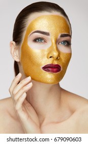 Portrait Of Beautiful Healthy Girl With Beauty Gold Mask. 