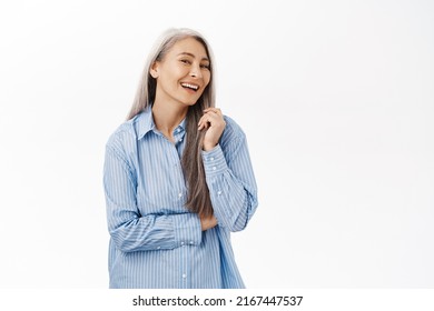 Portrait Of Beautiful, Healthy And Happy Old Korean Woman, Laughing And Smiling, Standing Over White Background