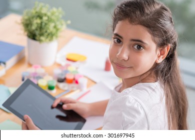 Portrait Of Beautiful Hispanic Preteen Girl With A Digital Tablet