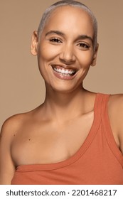 portrait of beautiful hispanic woman in her 20s with shaved hair smiling happy on neutral background Stock Photo
