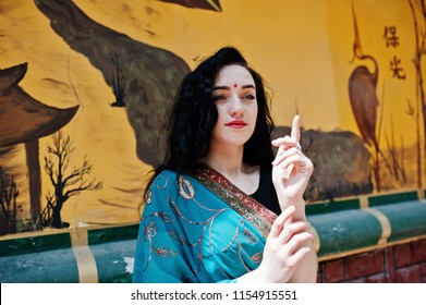 Portrait Of Beautiful Indian Brumette Girl Or Hindu Woman Model Against Japanese Grafiti Wall.