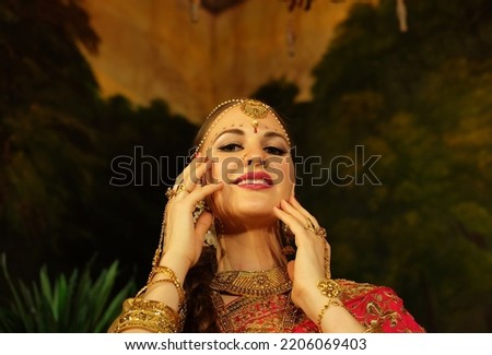 Portrait of beautiful indian female. Young hindu woman model in sari and kundan jewelry. Traditional India costume lehenga choli. Eastern, muslim or Arabic culture.