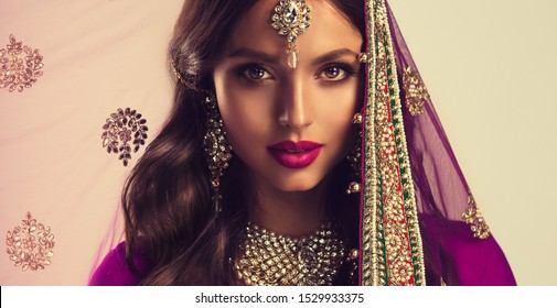 Portrait of beautiful indian girl . Young hindu woman model  in sari and  kundan jewelry . Traditional India costume lehenga choli . Eastern or Arabic culture. - Powered by Shutterstock