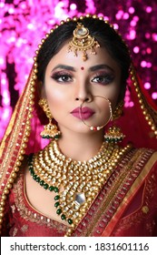 Portrait of beautiful Indian girl. Young female model with kundan jewelry set and Traditional Indian costume lehenga choli or sari.