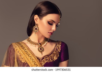 Portrait of beautiful indian girl. Young India woman model with kundan jewelry set. Traditional Indian costume lehenga choli or sari