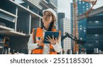 Portrait of a Beautiful Japanese Female Civil Engineer Working on a Tablet at a Construction Site. Young Asian Woman Standing Outdoors, Using Computer for Planning and Developing a Real Estate Project