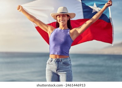 portrait beautiful latin woman holding a flag of Chile outdoors against blue sky, celebration and patriotism concept - Powered by Shutterstock