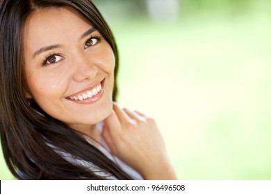 Portrait of a beautiful Latin woman smiling - outdoors