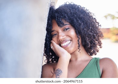 Portrait Of Beautiful Latina Woman. Smiling Dreamy Beautiful Latina Girl With Black Curly Hair Outside In The City.