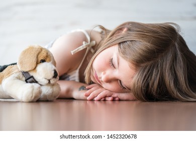 Portrait Of Beautiful Little Girl Sleeping With Her Favorite Plush Stuffed Animal Dog Doll Toy