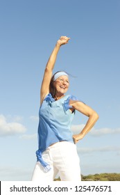 Portrait Beautiful Looking Middle Aged Woman Confident, Happy And Successful Smiling, Enjoying Active Retirement, Isolated With Blue Sky As Background And Copy Space.