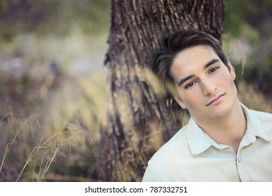 Portrait of a Beautiful man sitting by the almond tree feeling contemplative - Powered by Shutterstock