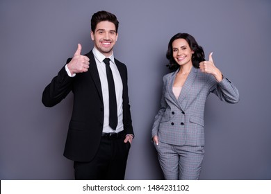 Portrait Of Beautiful Man And Woman Business People Having Brunet Wavy Curly Hairstyle Showing Thumb Up Wearing Black Tux Tuxedo Suit Isolated Over Grey Background