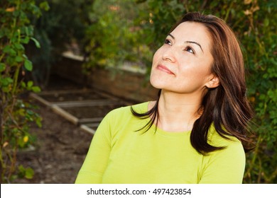 Portrait Of A Beautiful Mature Hispanic Woman Looking Up.