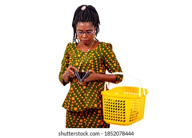 Portrait Of A Beautiful Mature Woman Holding Empty Shopping Cart And Looking Inside Her Wallet.