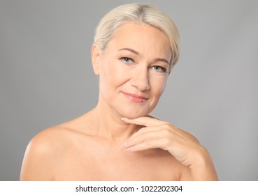Portrait Of Beautiful Mature Woman On Grey Background. Skin Care Concept
