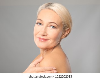 Portrait Of Beautiful Mature Woman On Grey Background. Skin Care Concept