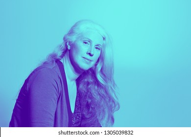 Portrait Of A Beautiful Middle Aged Woman With Long Wavy Hair In Trendy Duotone Effect, Copy Space.