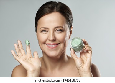 Portrait Of A Beautiful Middle Aged Woman With Green Mud Mask 