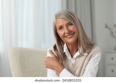 Portrait of beautiful middle aged woman at home, space for text - Powered by Shutterstock